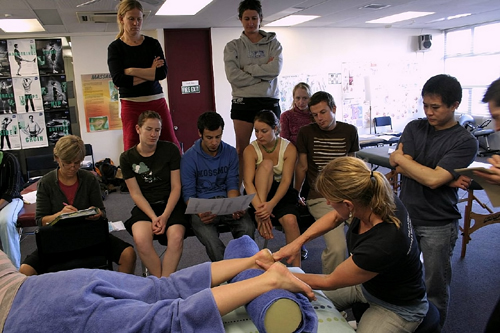 Massage Teacher Demonstrating On Student in Class